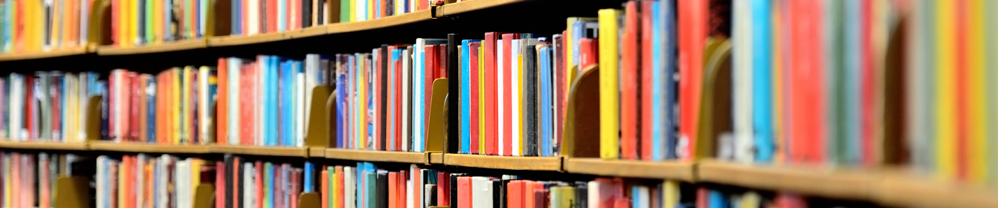 Curved rows of book shelving and colorful books.
