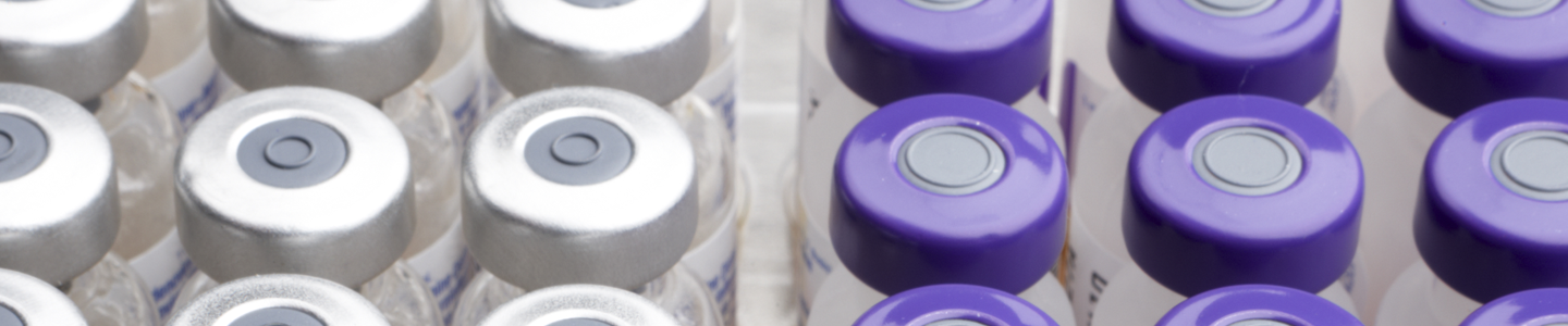 Rows of vials sealed with silver and purple caps.