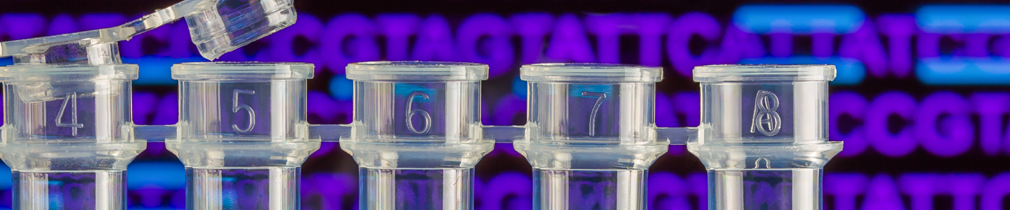 Row of small clear bottles, containing clear blue liquid, sequences in background.