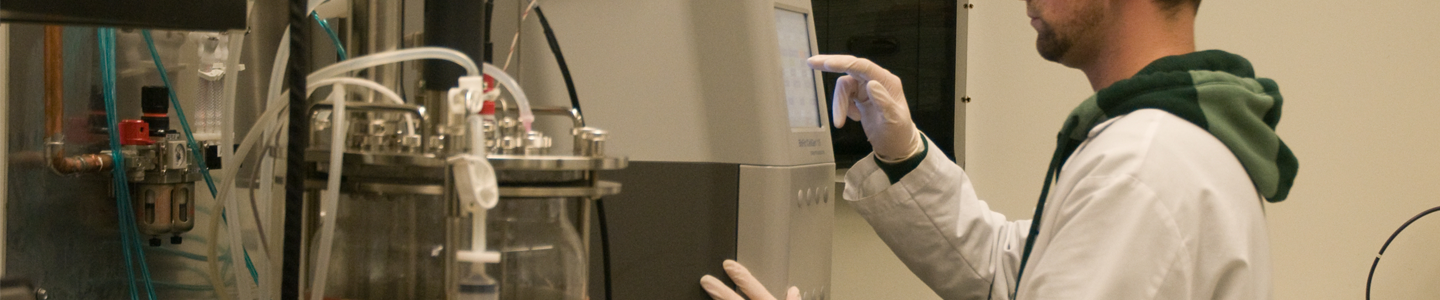 ATCC scientist standing at lab equipment.