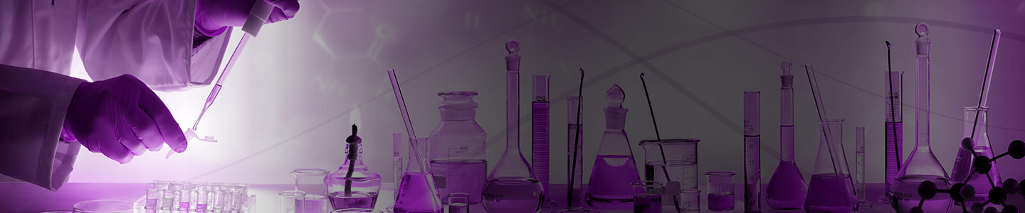 Hands using syringe to fill mini vial above tray of vials on table near petri dishes, bottles, beakers, and flasks.