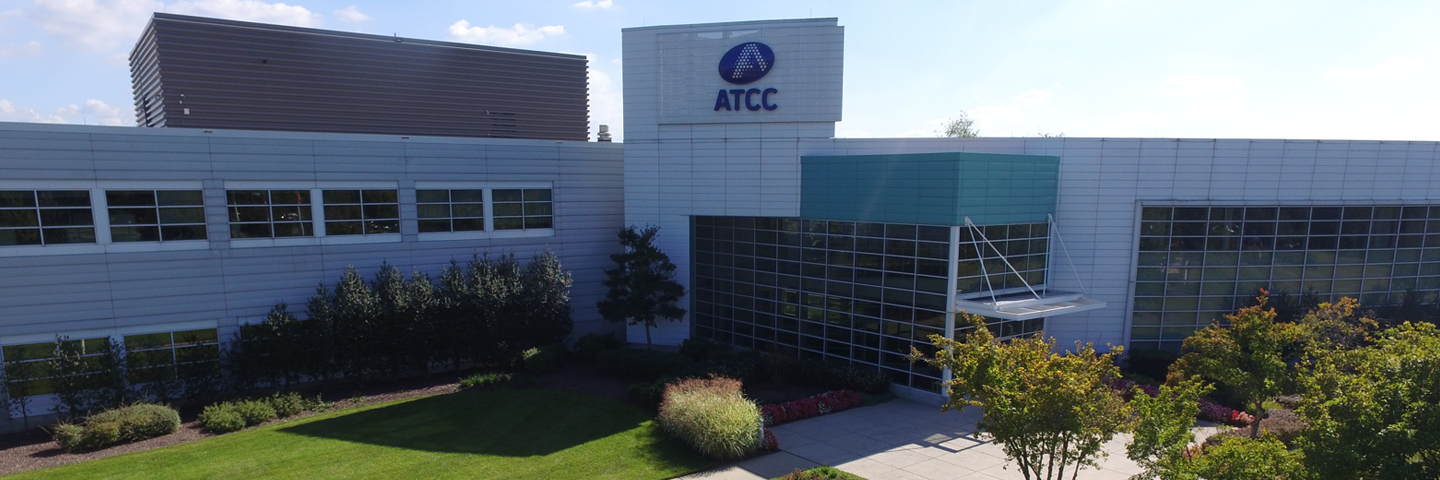 ATCC headquarters building and "ATCC" sign and flags in Manassas, Virginia.