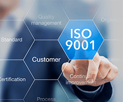 Man in a suit pointing to an blue octagon labeled ISO 9001 next to octagons with words like Customer, Certification and Standard.