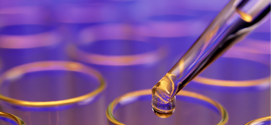 eye-dropper-test-tubes Eye dropper with drop of clear liquid, over top of row of test tubes.