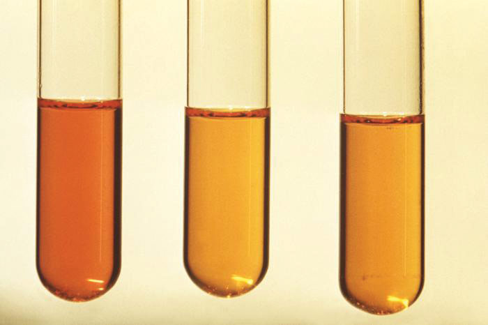 three test tubes with orange liquid